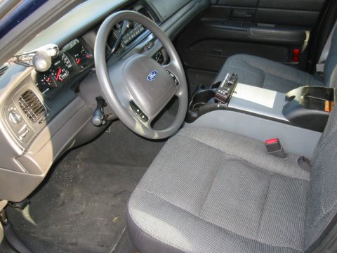 2003 Ford Crown Victoria - Interior view of a 2003 Ford Crown Victoria, showing the dashboard, steering wheel, and front seats.