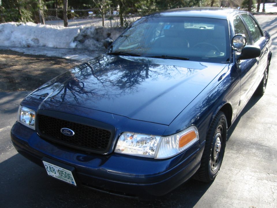Blue 2003 Ford Crown Victoria with light bar
