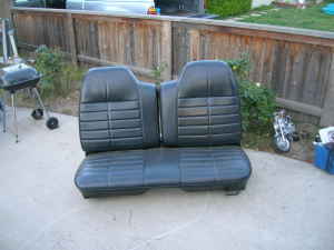 1972 Ford Ranchero - A black vinyl car seat with distinct horizontal pleating is shown outdoors.
