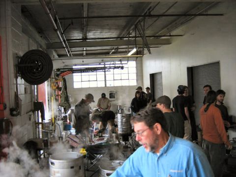 1985 Ford LTD Crown Victoria - Workshop scene with multiple people and brewing equipment, steam visible.