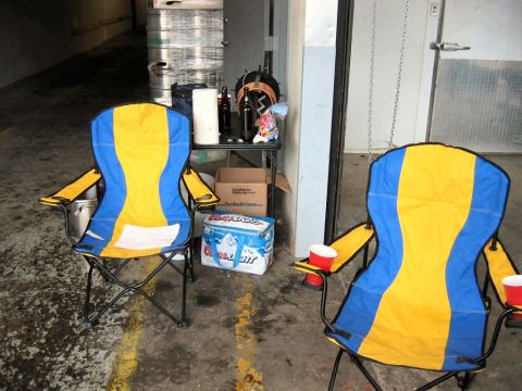 1985 Ford LTD Crown Victoria - Folding chairs and beer kegs are visible in what appears to be a storage area or brewery.