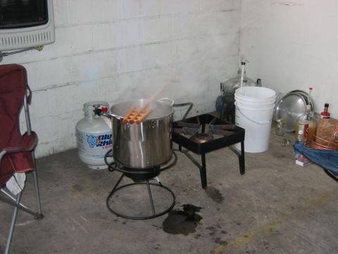 1985 Ford LTD Crown Victoria - Hot dogs are being prepared for boiling in a large pot, with a propane tank nearby.