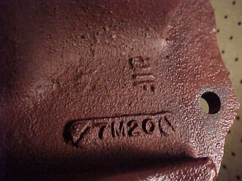 1968 Mercury Cougar - A close-up view of a cast iron component shows stamped identification marks and manufacturing marks.