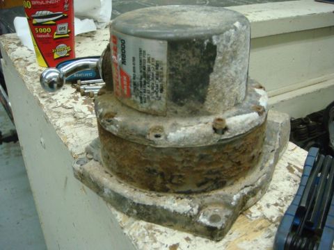 1996 Ford Bronco - A weathered winch motor, identified as an M8000 model, sits on a workbench next to tools.