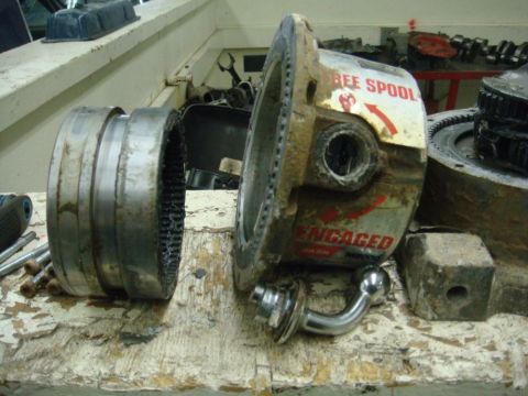 1996 Ford Bronco - A disassembled winch spool part is shown, with visible text indicating 'BEE SPOOL' and 'ENGAGED'.