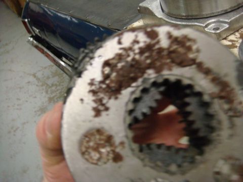 1996 Ford Bronco - A close-up view of a heavily rusted metal component, possibly a gear or hub, showing internal teeth.