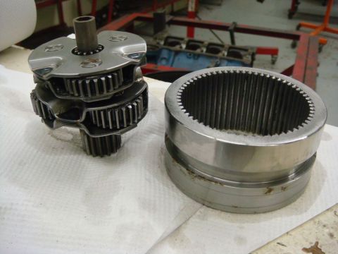 1996 Ford Bronco - A close-up view of disassembled transmission or transfer case components, including a gear cluster and a splined housing.
