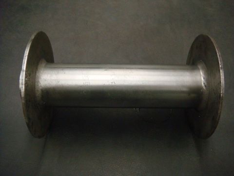 1996 Ford Bronco - A metal spool, likely a component for a winch or similar machinery, is shown against a dark background.