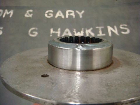 1996 Ford Bronco - Close-up of a metal part with splines, with text visible on the wall behind it.