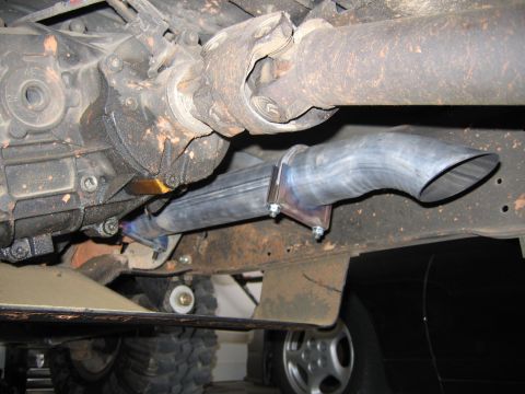 1989 Ford Bronco - Custom exhaust pipe installed on a vehicle's undercarriage, near the driveshaft and differential.