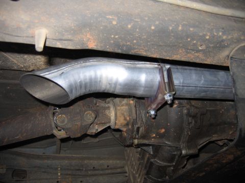 1989 Ford Bronco - Close-up of the underside of a vehicle, focusing on the exhaust system and drivetrain components.