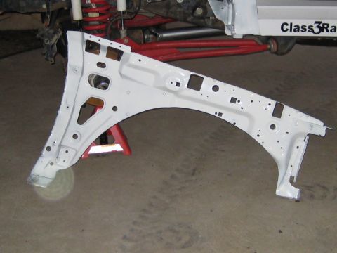 1996 Ford Bronco - Freshly painted white inner-fender apron panel standing on a concrete garage floor, shown from its inner side with all factory mounting hol…
