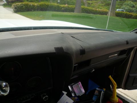 1975 Ford Ranchero - The interior of a vehicle shows a worn dashboard with visible cracks and repairs.