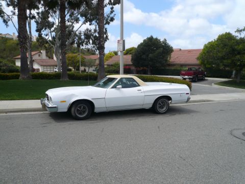 1975 Ford Ranchero - A white 1975 Ford Ranchero is parked curbside in a suburban neighborhood.