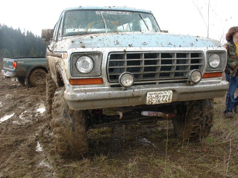 1978 Ford Bronco - Muddy 1978 Ford Bronco parked in a field with another truck behind it.