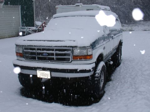 1978 Ford Bronco - Ford Bronco parked outside in a snowstorm, with a Washington license plate.