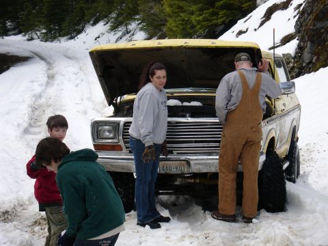 1978 Ford Bronco - Family checks under the hood of a 1978 Ford Bronco stuck in the snow.