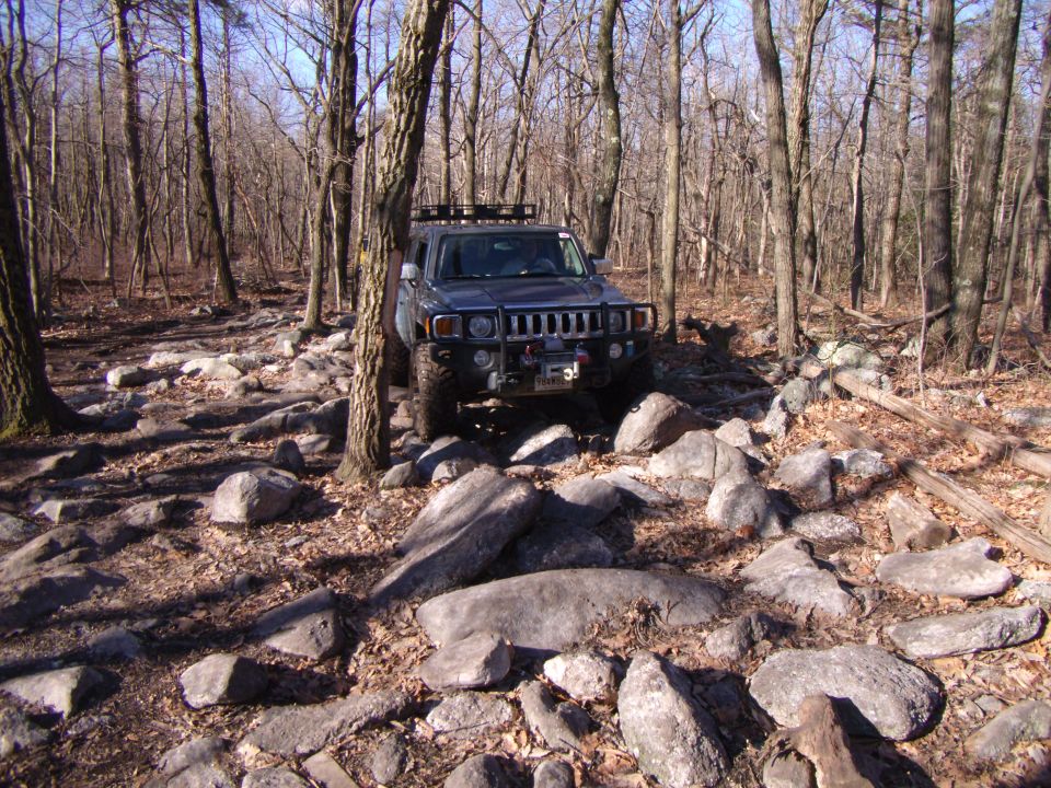 Gray Hummer H3 on rocky trail