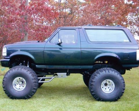 1994 Ford Bronco - This modified Ford Bronco has a lifted suspension and oversized tires, suggesting a model year between 1992 and 1996.