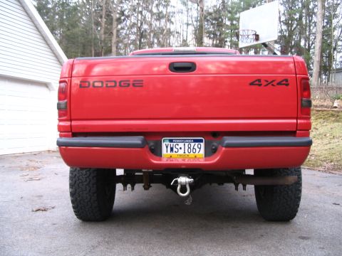 1997 Dodge 1500 - Rear view of a red 1997 Dodge 1500 pickup truck, showing the tailgate, bumper, and 4x4 badging.