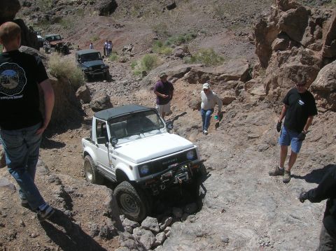 1985 Ford Bronco - Several off-road vehicles navigate a rocky canyon trail during an outing.