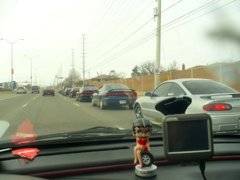 1993 Ford Probe - Driving in a convoy on a cloudy day, with several cars in front.
