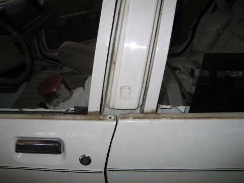 1991 Ford LTD Crown Victoria - Interior view of a white 1991 Ford Crown Victoria LTD, highlighting the door panel and dashboard details.