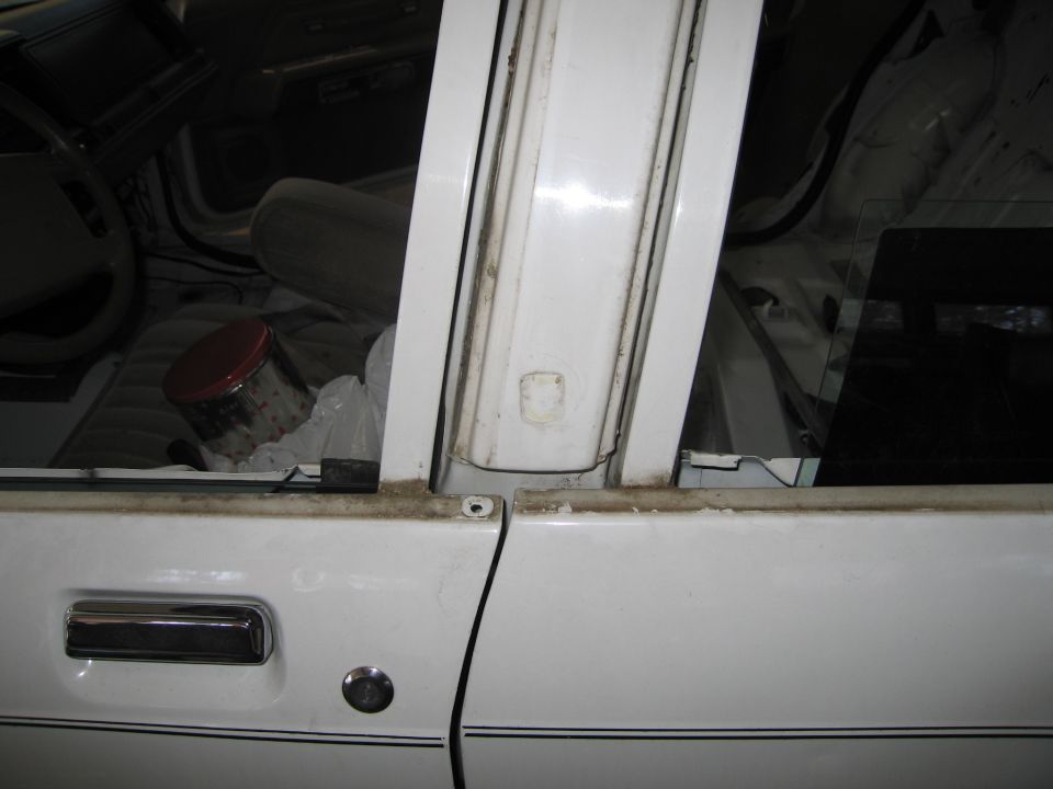 Interior of a white 1991 Ford Crown Victoria LTD showing door panel and dashboard