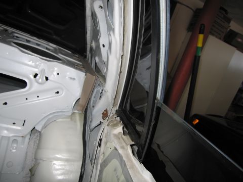 1991 Ford LTD Crown Victoria - The interior of a car's door frame is shown, revealing exposed metal and some signs of rust.