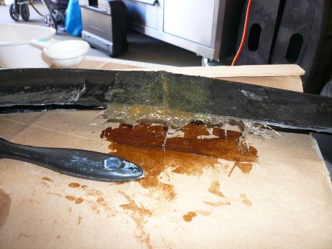 1996 Ford Probe - A damaged car part is being repaired with adhesive and fiberglass material.
