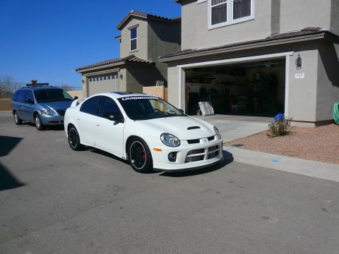 1996 Ford Probe - A white Dodge Neon SRT-4 is parked in a driveway with a blue minivan behind it.