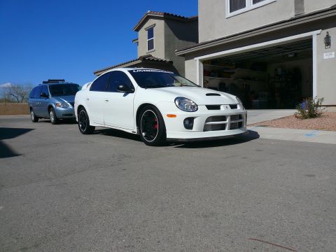 1996 Ford Probe - White Dodge Neon SRT-4 parked in a driveway, with a blue minivan behind it.