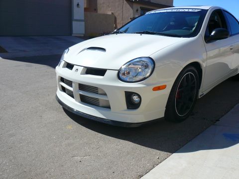 1996 Ford Probe - This white Dodge Neon SRT-4 features an aggressive front bumper with an exposed intercooler, indicating performance modifications.