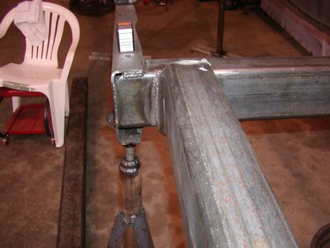 1991 Ford Bronco - Close-up of a welded metal frame section supported by jack stands.