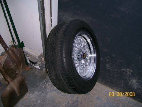 1995 Mercury Grand Marquis - A single tire and chrome mesh rim with a gold emblem is pictured, likely a replacement part.