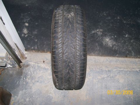 1995 Mercury Grand Marquis - A single tire is shown on a concrete floor with a date stamp in the corner.