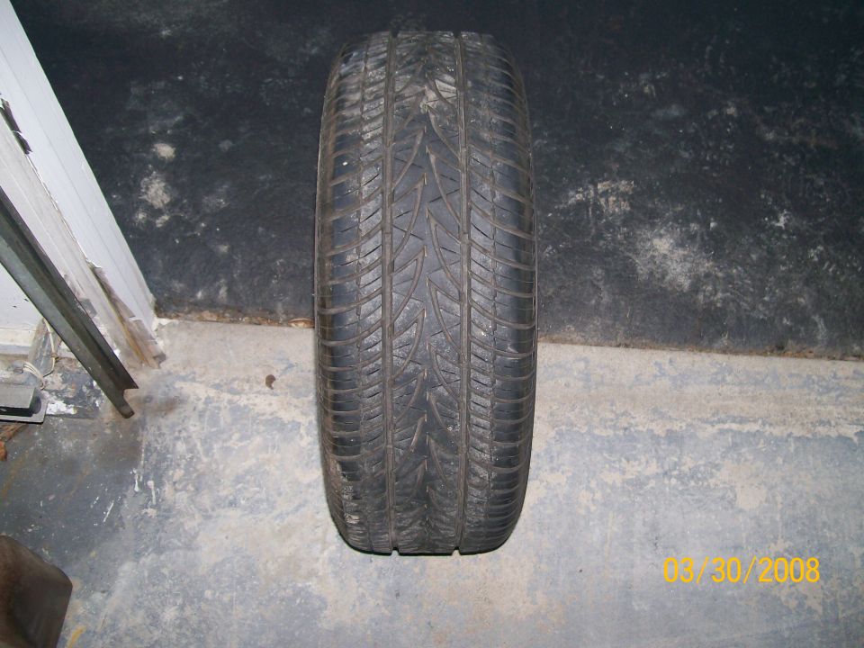 Tire on concrete floor, showing tread pattern. Date stamp 03/30/2008