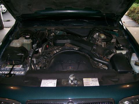 1995 Mercury Grand Marquis - The engine compartment of a 1995 Mercury Grand Marquis is open for inspection.
