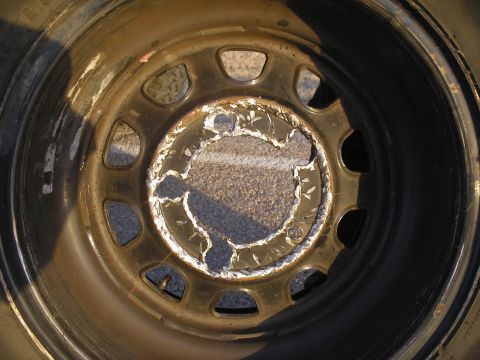 1990 Ford Bronco - Close-up of a damaged wheel rim showing significant wear and tear.