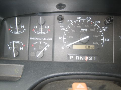 1995 Ford Bronco - Close-up of a vehicle's dashboard gauges, including speedometer, fuel, and temperature indicators.