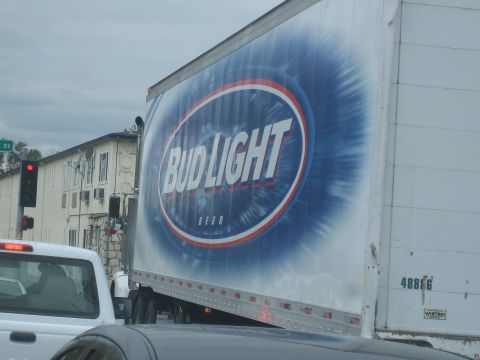 1995 Ford Bronco - A Bud Light trailer truck is seen from the side, with a white pickup truck in the foreground.