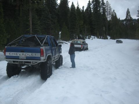 1995 Ford Bronco - Modified Chevrolet pickup truck and other vehicles in a snowy forest scene.