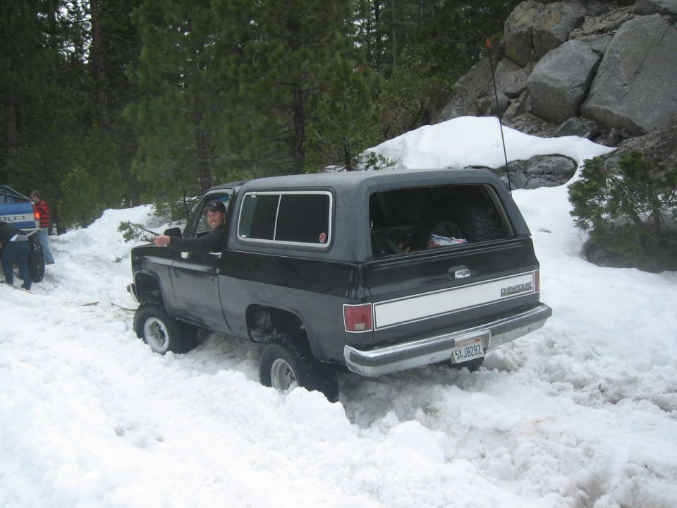 Guy in black K5 Blazer stuck in snow, another vehicle behind him