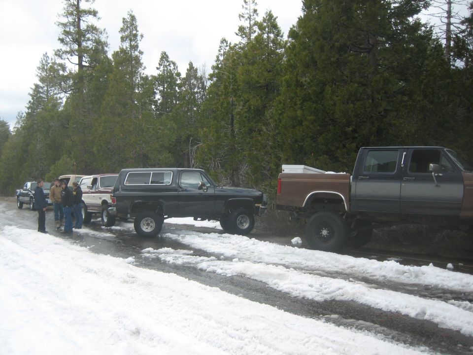 Black SUV with lifted suspension parked on a snowy road