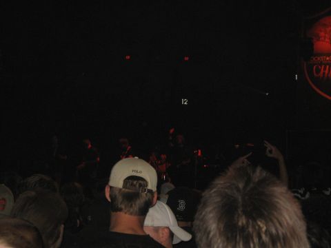 1988 Ford Bronco - A crowd watches a band perform on stage at a concert venue.