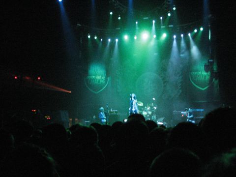 1988 Ford Bronco - A band performs on stage at a concert, illuminated by stage lights, with a crowd watching.