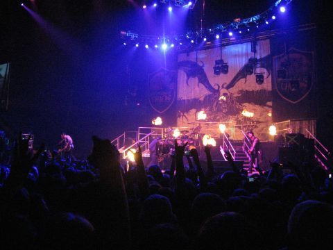 1988 Ford Bronco - A band plays a concert with dramatic lighting and stage effects, including fire and a large dragon graphic.
