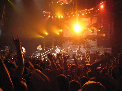 1988 Ford Bronco - A band performs live on stage for an enthusiastic audience at a concert venue.
