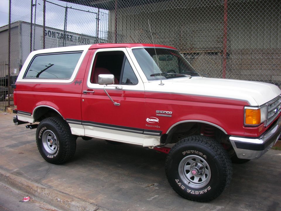 Red and white 1989 Ford Bronco with Rancho suspension