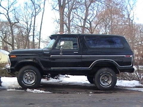 1990 Ford Bronco - This black Ford Bronco is parked outside in a snowy area.